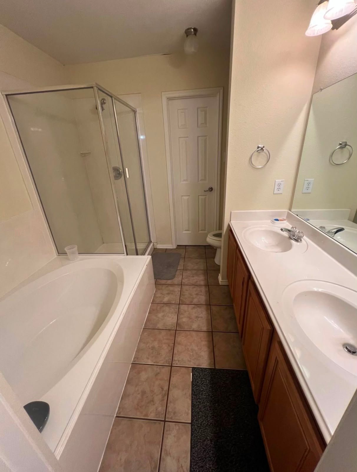 Clean bathroom with bathtub, shower, and vanity
