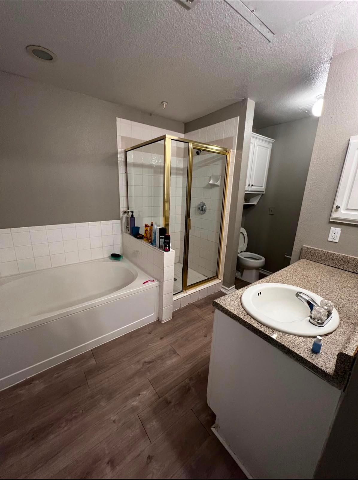 Fresh bathroom with clean tub, shower, and floor