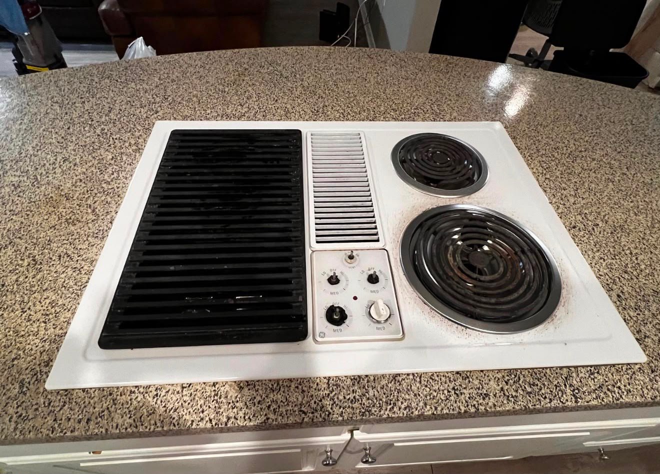 Clean white stovetop and polished counter